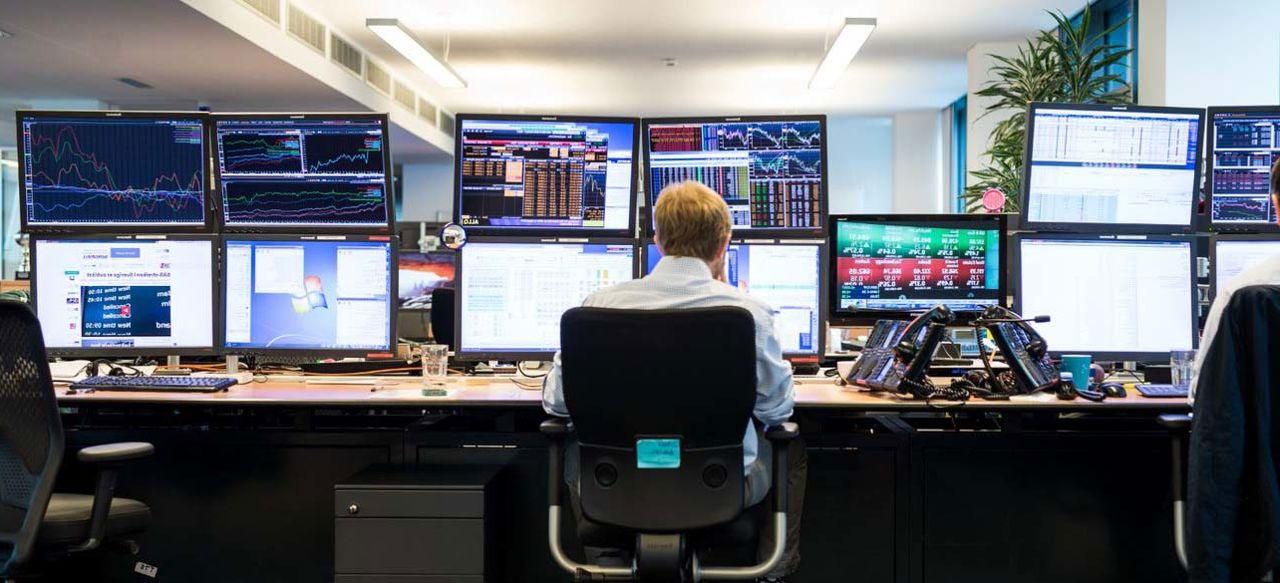 Man in front of monitors